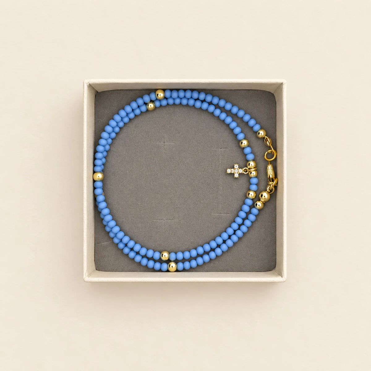 Pulsera azul con cruz