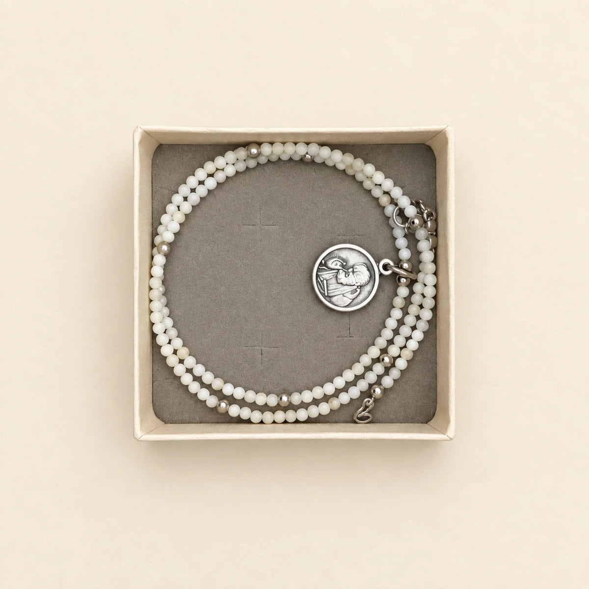 Pulsera blanca con medalla circular